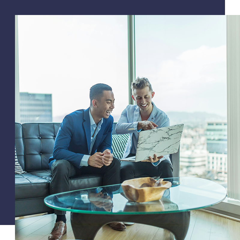 Two young businesspeople having fun while working together in the office