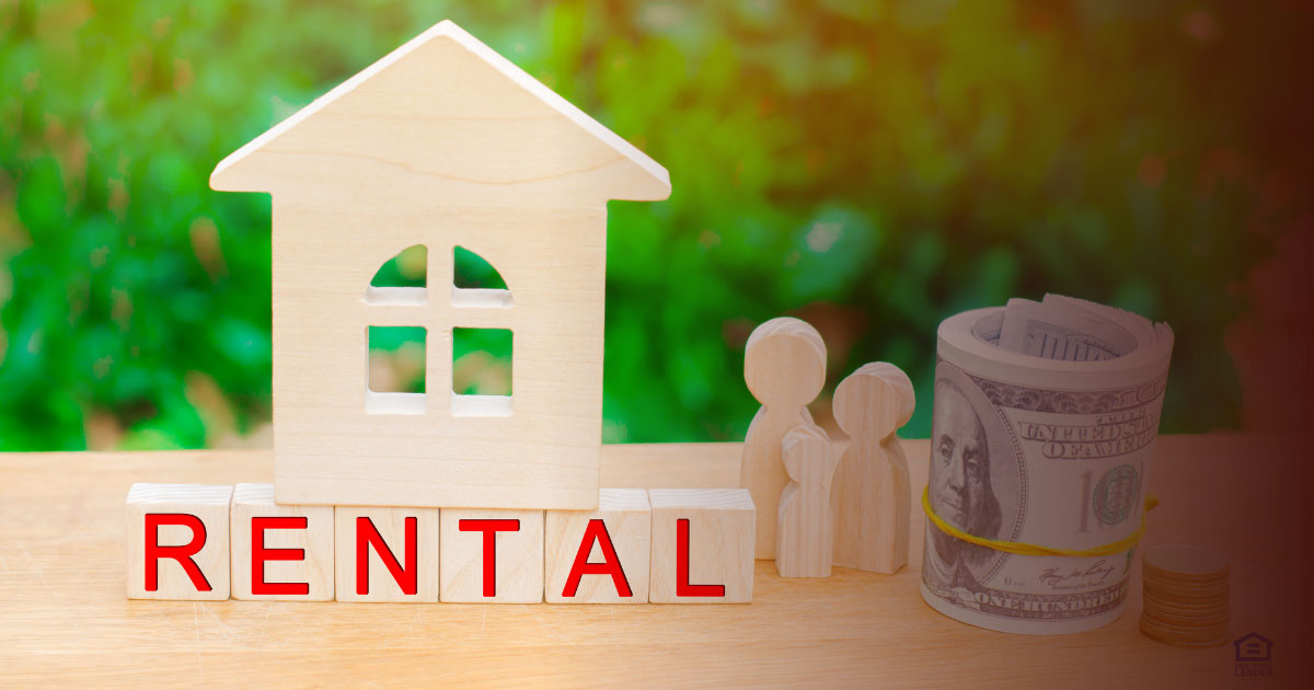 The family with money is standing near their house on wooden blocks.