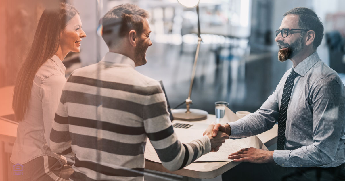 Couple reviewing real estate 2025 opportunities in a buyer’s market with loan officer